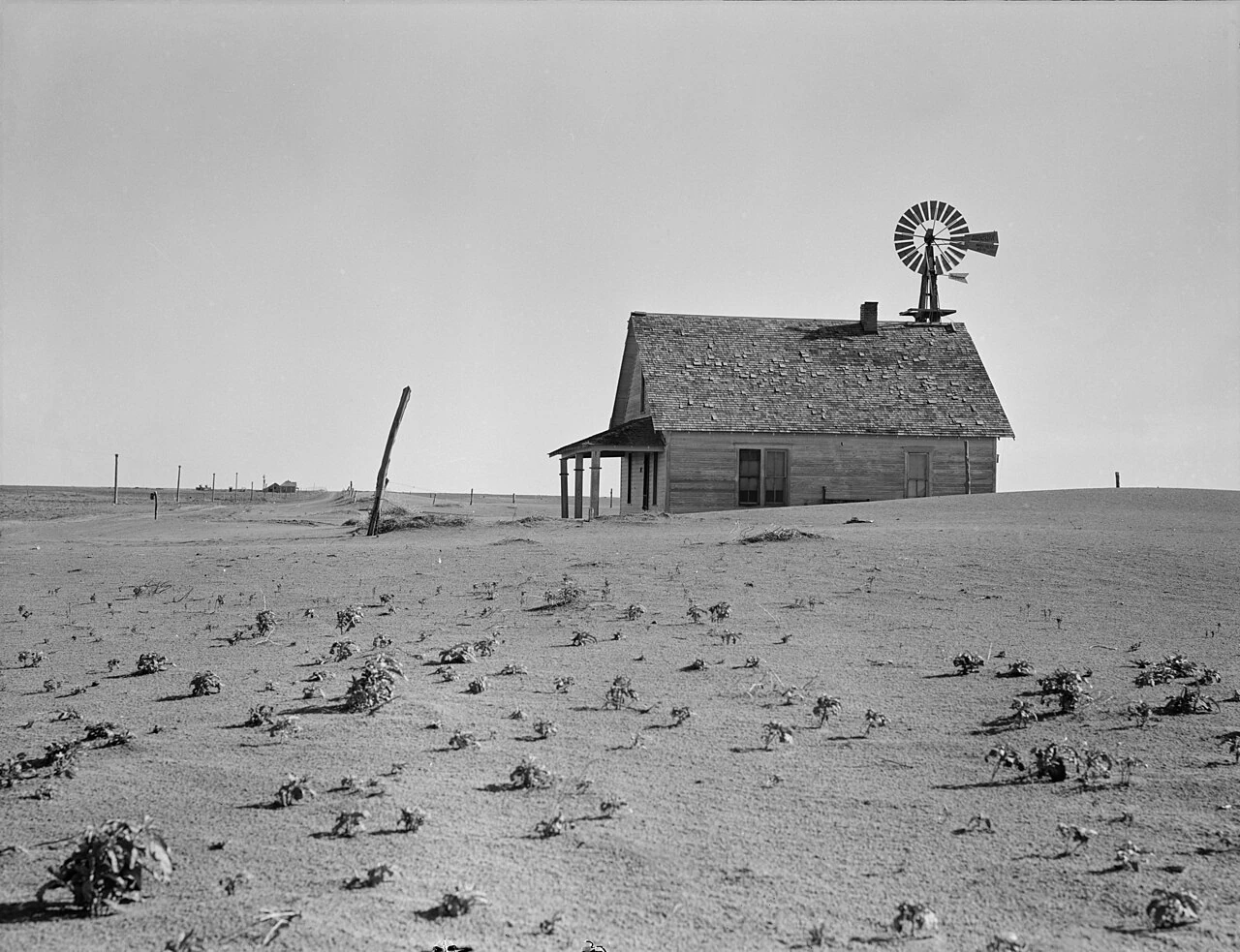 Dorothea Lange's 1938 photo of a Dust Bowl farmhouse half buried in blown topsoil near Dalhart, Texas